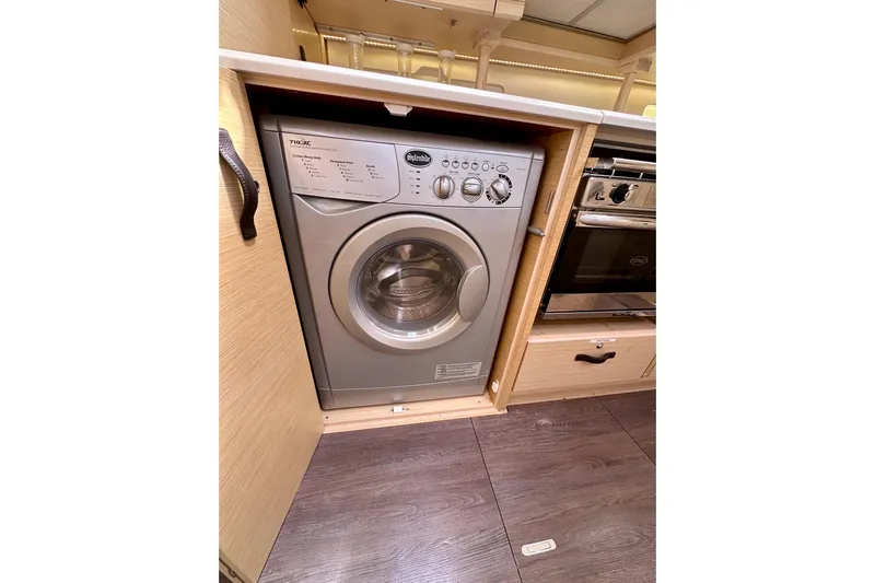  Yacht Photos Pics Washing machine in 2018 Jeanneau 54 yacht's wooden interior kitchen.