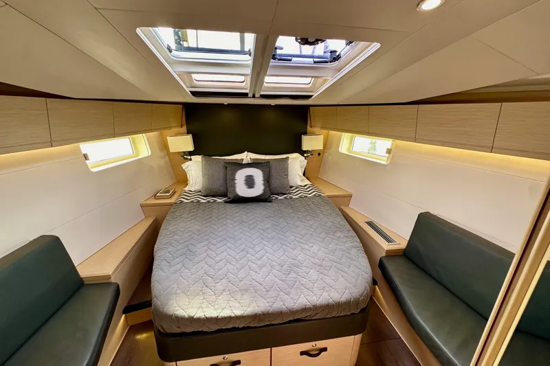  Yacht Photos Pics Luxurious cabin interior of 2018 Jeanneau 54 yacht with skylight and modern furnishings.