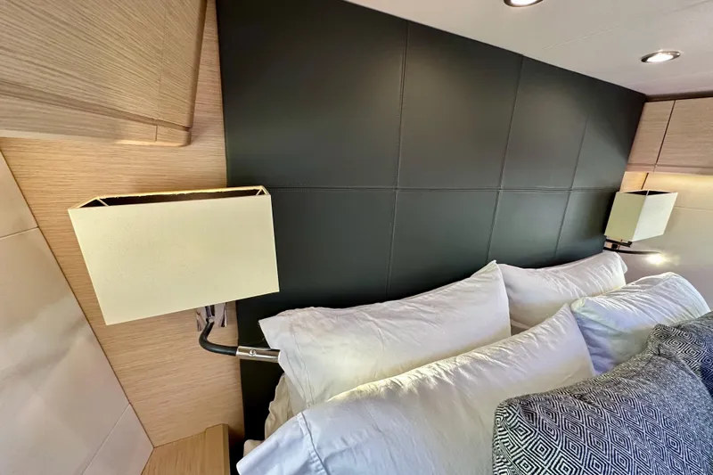  Yacht Photos Pics Luxurious interior of 2018 Jeanneau 54 yacht with elegant bedding and modern lighting.