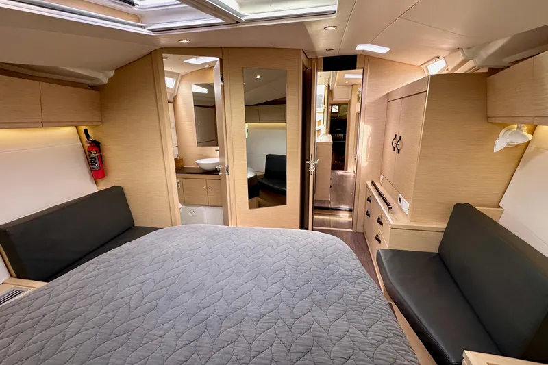  Yacht Photos Pics Luxurious interior of a 2018 Jeanneau 54 yacht, featuring a cozy bedroom and modern amenities.