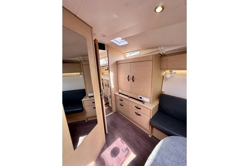  Yacht Photos Pics Interior of 2018 Jeanneau 54 yacht, featuring modern wood cabinetry and seating.