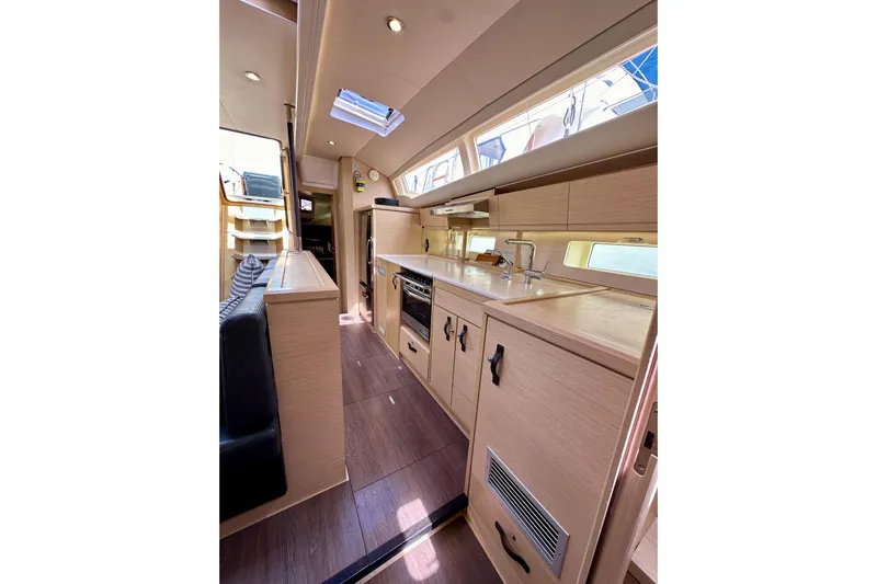  Yacht Photos Pics Luxurious interior of 2018 Jeanneau 54 yacht with modern kitchen and seating area.