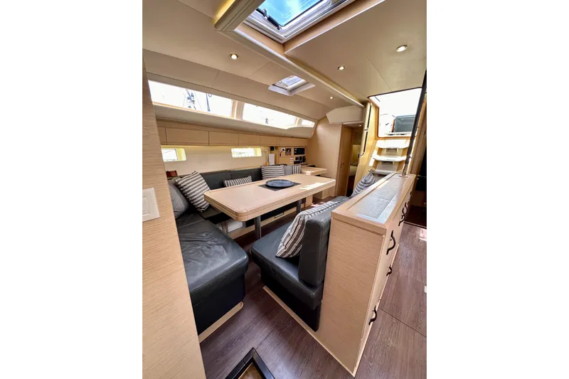  Yacht Photos Pics Luxurious interior of 2018 Jeanneau 54 yacht with modern seating and dining area.