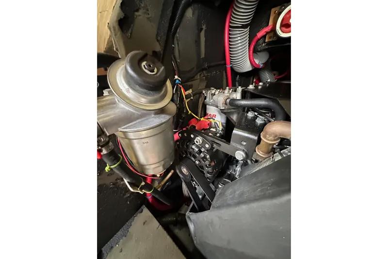 Yacht Photos Pics Engine compartment of a 2018 Jeanneau 54 sailboat, showcasing mechanical components and wiring.