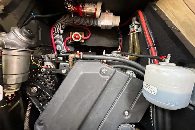  Yacht Photos Pics Engine compartment of a 2018 Jeanneau 54 sailboat, showcasing mechanical components and wiring.