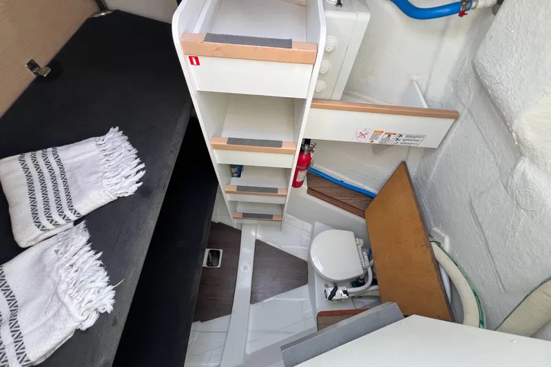  Yacht Photos Pics Interior of 2018 Jeanneau 54 yacht featuring compact bathroom and storage shelves.