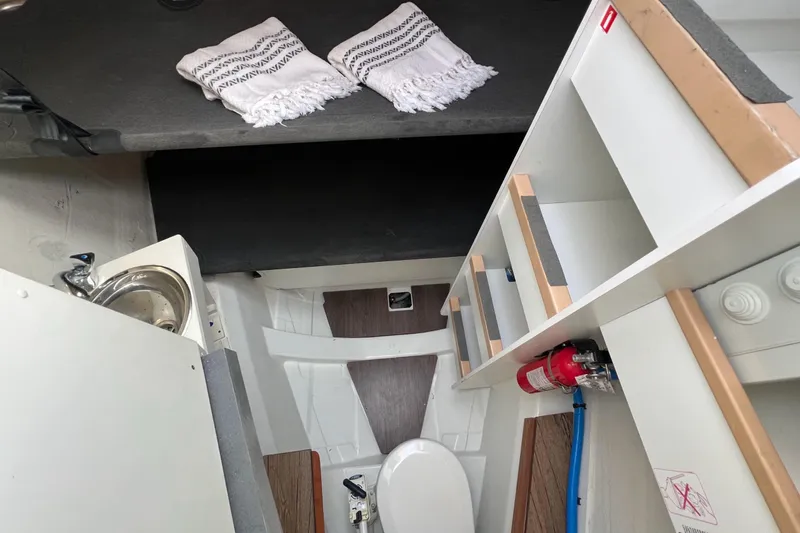  Yacht Photos Pics Interior of 2018 Jeanneau 54 yacht featuring compact bathroom and storage area.