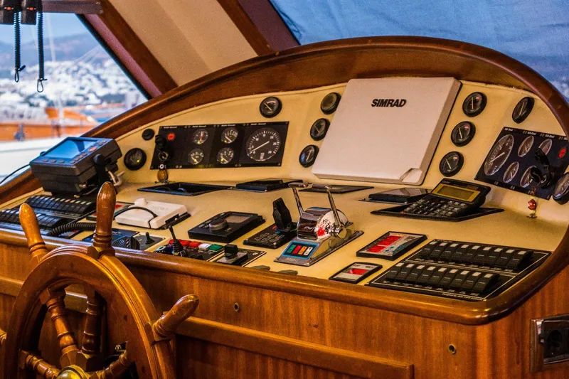 Papa Joe Yacht Photos Pics Cockpit of 2007 Mastori Gulet with navigation instruments and wooden steering wheel.