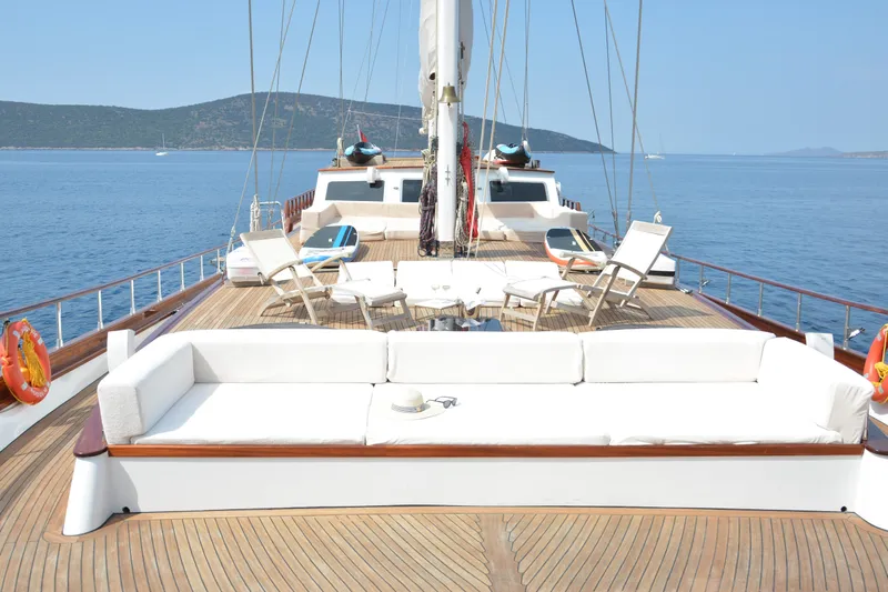 Papa Joe Yacht Photos Pics Luxurious 2007 Mastori Gulet yacht deck with seating, sun loungers, and ocean view.