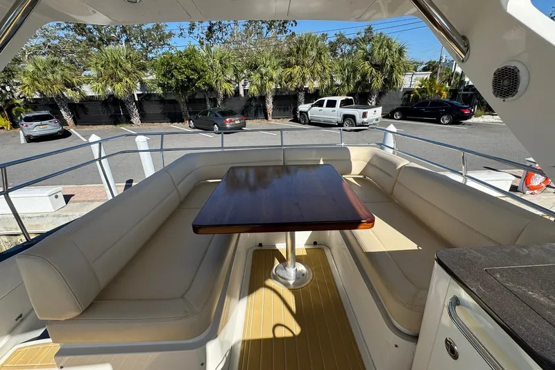 Bateau D&rsquo;amis Yacht Photos Pics Luxurious seating area on 2016 Sea Ray 510 Fly yacht with wooden table.