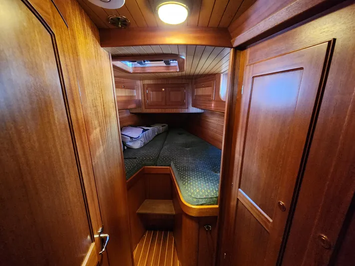 Lizette Yacht Photos Pics Cozy wooden cabin interior of Regina 43 yacht, featuring a bed and storage, year 2000 model.