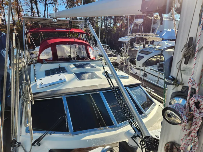 Lizette Yacht Photos Pics Sailboat Regina 43, year 2000, docked with red canopy and visible rigging.