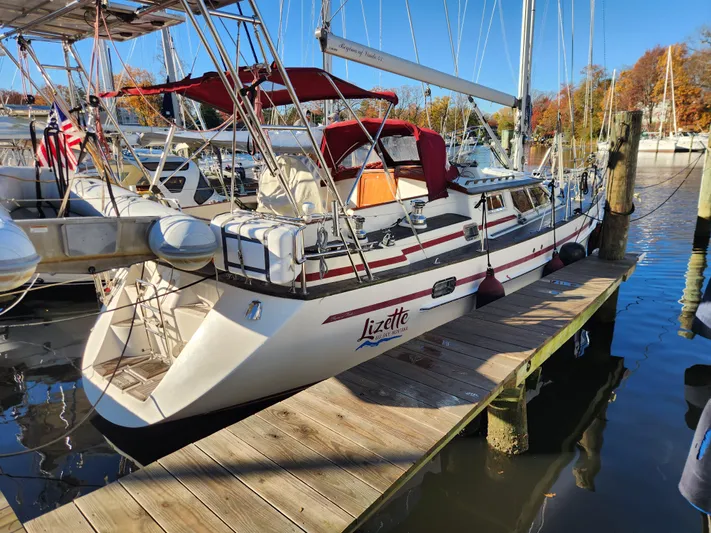Lizette Yacht Photos Pics Sailboat "Lizette" docked, Regina 43 model, 2000, with red canopy and American flag.