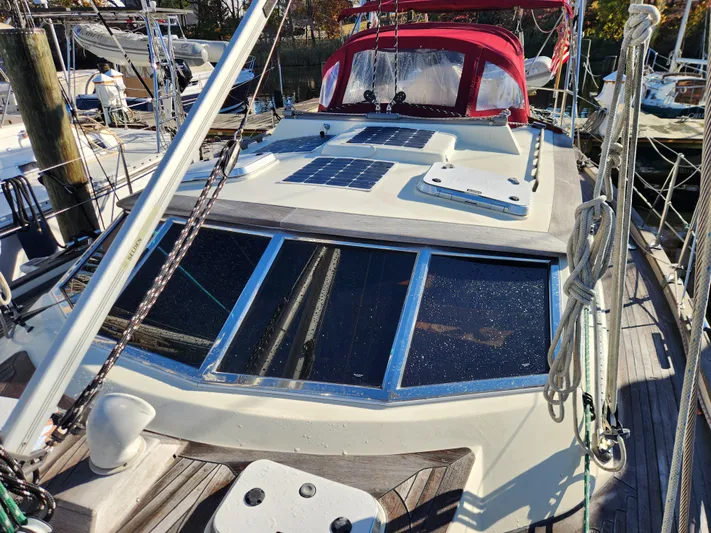 Lizette Yacht Photos Pics Sailboat Regina 43, 2000 model, docked with solar panels and red canopy.