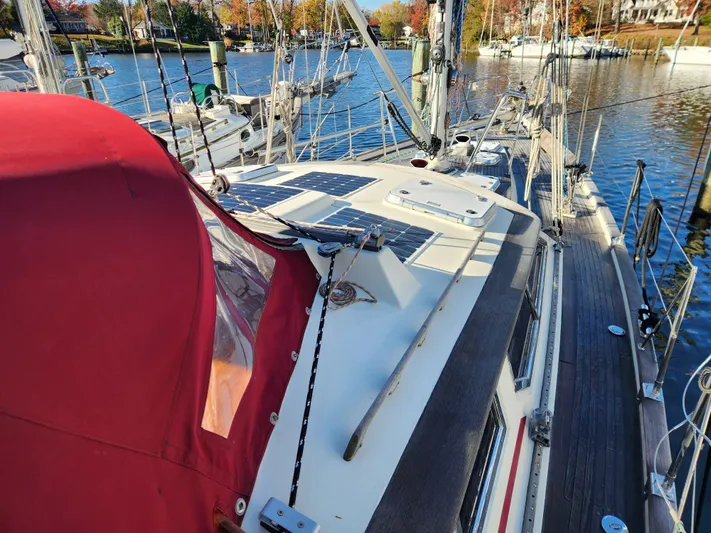 Lizette Yacht Photos Pics Sailboat docked at marina, featuring solar panels and red canopy, Regina 43 model, year 2000.