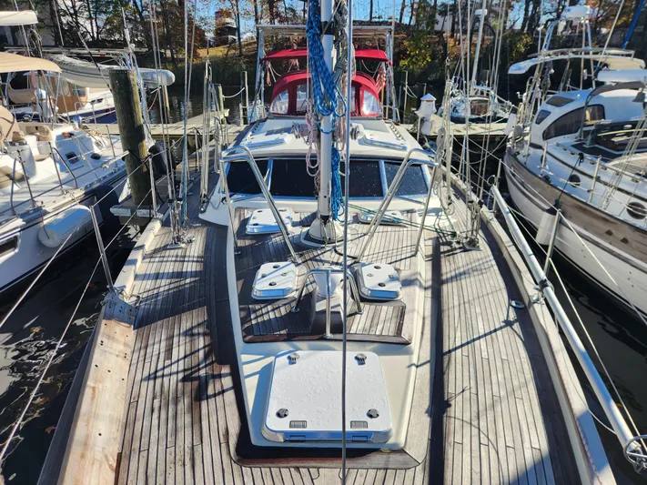 Lizette Yacht Photos Pics Sailboat docked at marina, Regina 43 model, year 2000, with wooden deck and rigging.