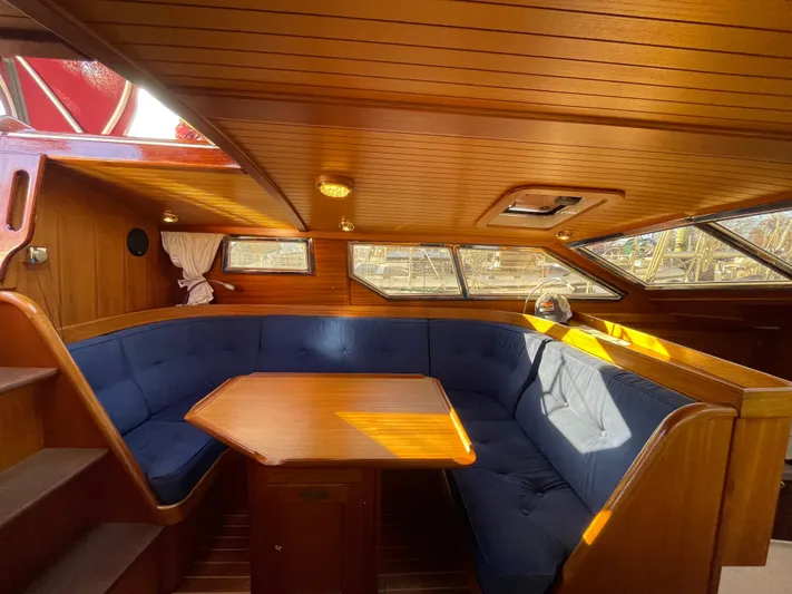 Lizette Yacht Photos Pics Luxurious Regina 43 yacht interior with wooden finish and blue cushioned seating, year 2000 model.