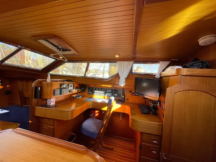 Lizette Yacht Photos Pics Luxurious Regina 43 yacht interior, featuring wooden furnishings and modern navigation equipment, built in 2000.