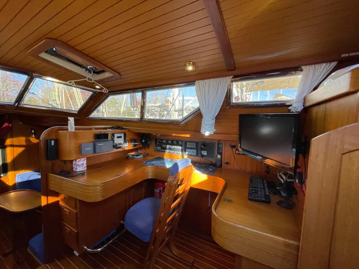 Lizette Yacht Photos Pics Interior of a 2000 Regina 43 yacht with wooden furnishings and navigation equipment.