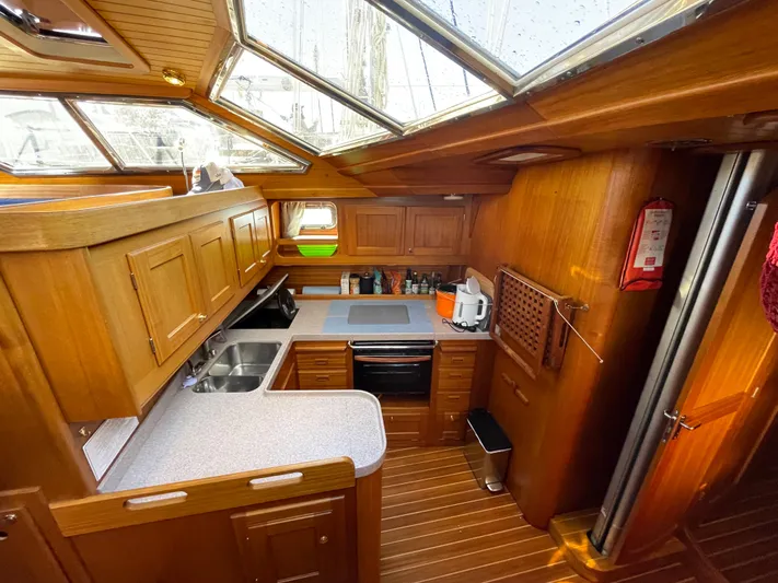 Lizette Yacht Photos Pics Wooden yacht kitchen interior with skylights, featuring Regina 43 model, 2000.