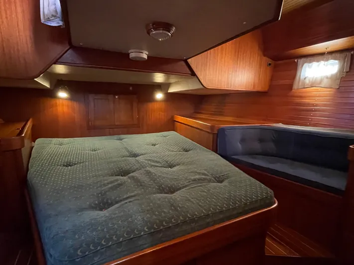 Lizette Yacht Photos Pics Luxurious cabin interior of a 2000 Regina 43 yacht with cozy bedding and seating.