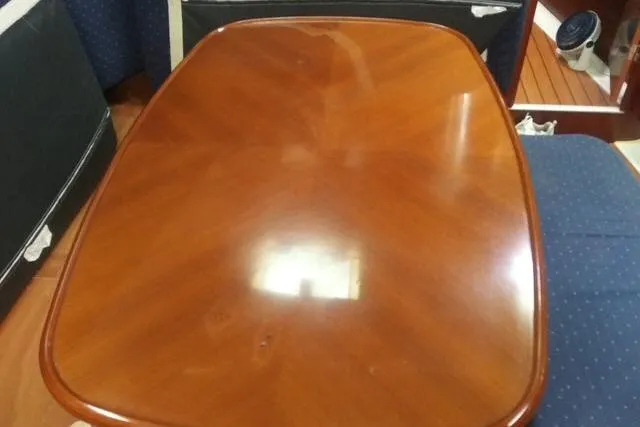 Pacifico Yacht Photos Pics Polished wooden table inside 2005 Beneteau 393 yacht cabin.