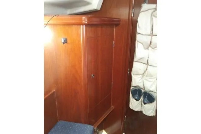 Pacifico Yacht Photos Pics Interior of 2005 Beneteau 393 yacht with wooden cabinetry and storage pockets.