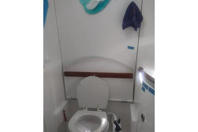 Pacifico Yacht Photos Pics Beneteau 393 2005 yacht bathroom with toilet and nautical decor.
