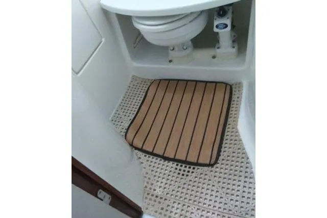 Pacifico Yacht Photos Pics 2005 Beneteau 393 yacht bathroom with toilet and striped mat.