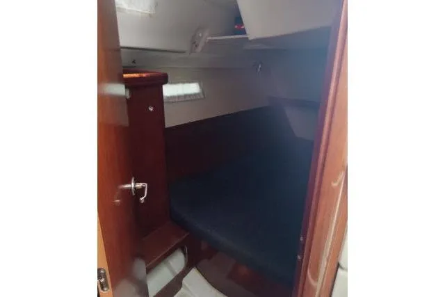 Pacifico Yacht Photos Pics 2005 Beneteau 393 cabin interior with wooden finish and cozy sleeping area.