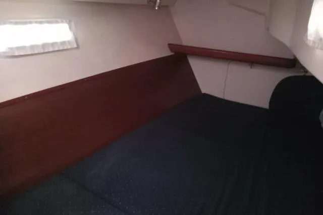 Pacifico Yacht Photos Pics 2005 Beneteau 393 cabin interior with wooden paneling and bed.