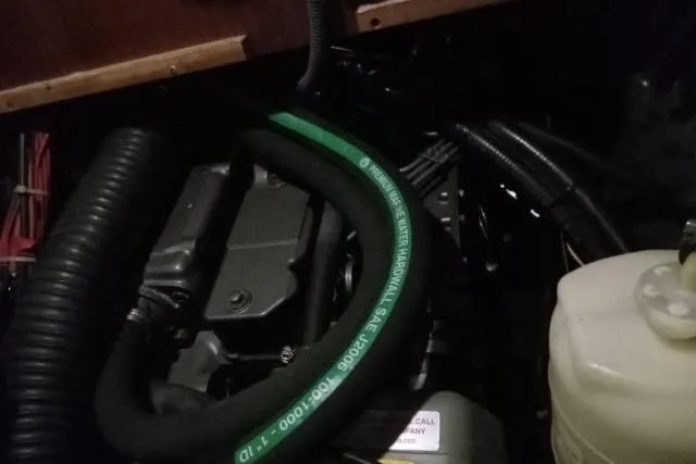 Pacifico Yacht Photos Pics Engine compartment of a 2005 Beneteau 393 sailboat, featuring hoses and components.