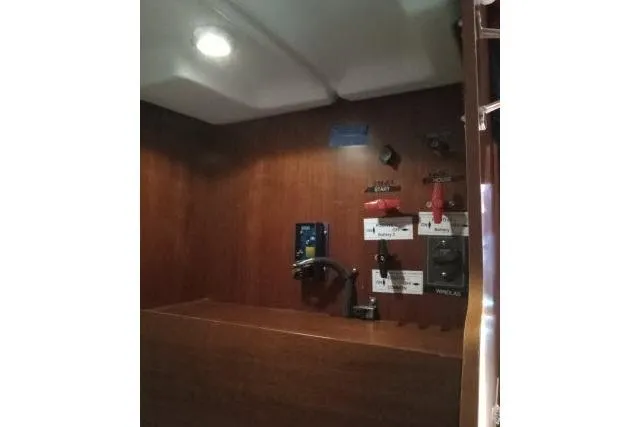 Pacifico Yacht Photos Pics Control panel inside 2005 Beneteau 393 yacht, featuring switches and wooden interior.