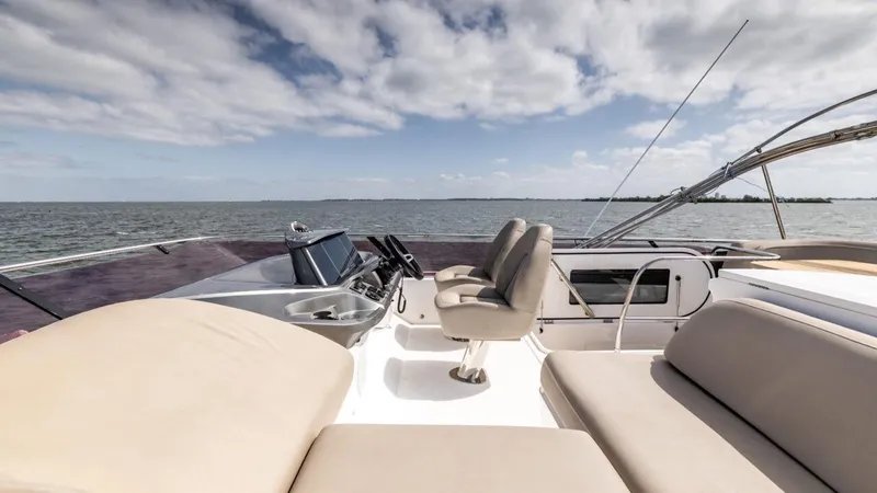  Yacht Photos Pics Luxurious 2019 Princess F45 yacht deck with seating, ocean view, and clear sky.