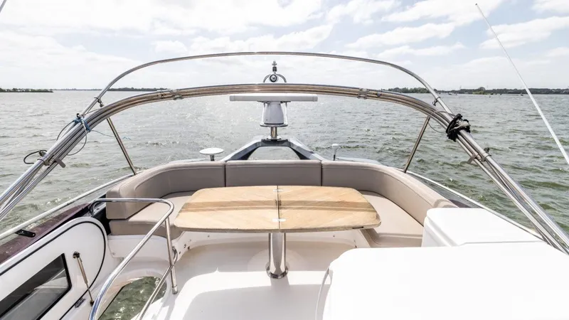  Yacht Photos Pics 2019 Princess F45 yacht deck with seating and table, overlooking calm waters.