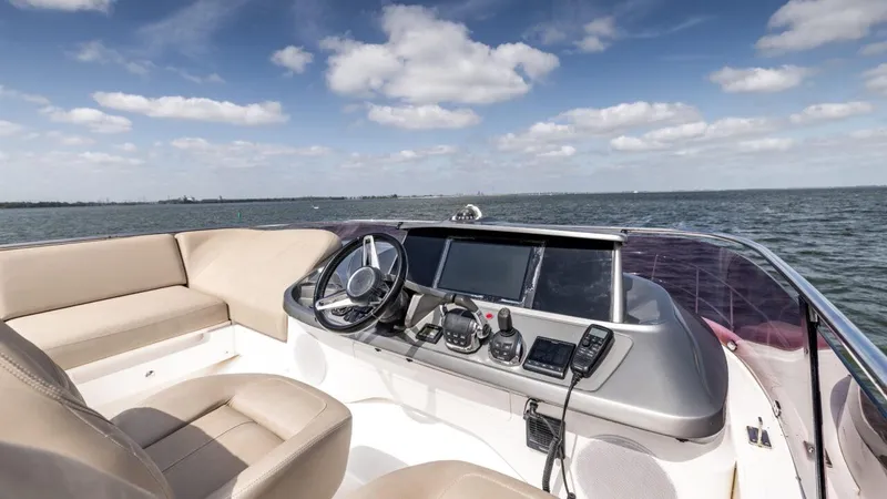  Yacht Photos Pics 2019 Princess F45 yacht helm with modern controls, beige seating, and ocean view.