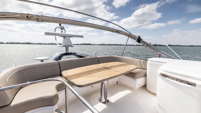  Yacht Photos Pics Luxurious 2019 Princess F45 yacht deck with seating and table, under a clear sky.
