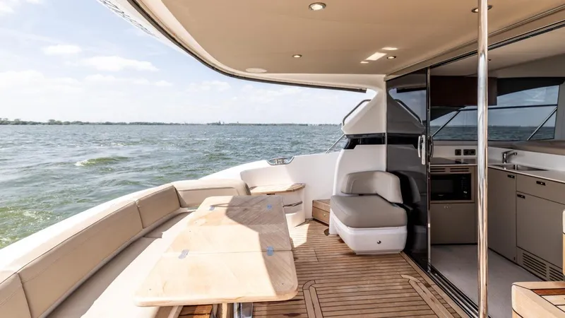  Yacht Photos Pics Luxurious 2019 Princess F45 yacht deck with seating, table, and ocean view.
