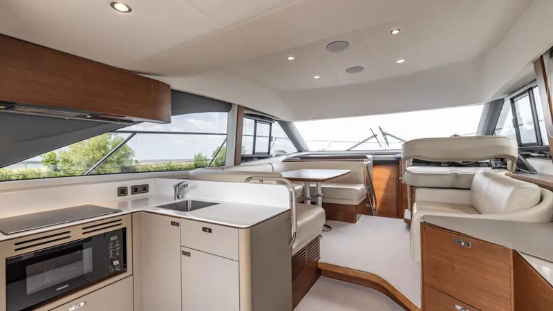  Yacht Photos Pics Luxurious interior of 2019 Princess F45 yacht with modern kitchen and seating area.