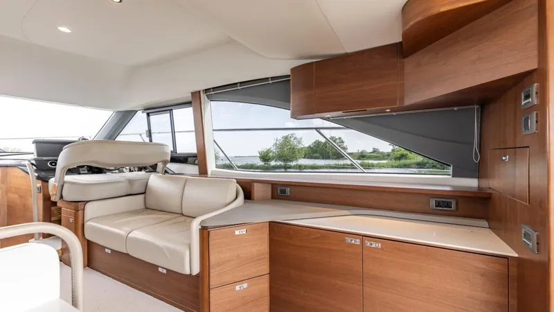  Yacht Photos Pics Luxurious interior of 2019 Princess F45 yacht with elegant wood finish and leather seating.
