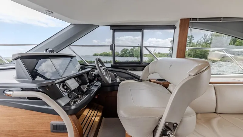  Yacht Photos Pics Interior of 2019 Princess F45 yacht, featuring modern helm and luxurious seating.