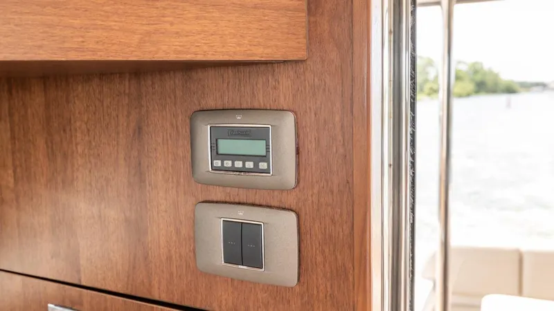 Yacht Photos Pics Control panel on 2019 Princess F45 yacht interior with wood finish.