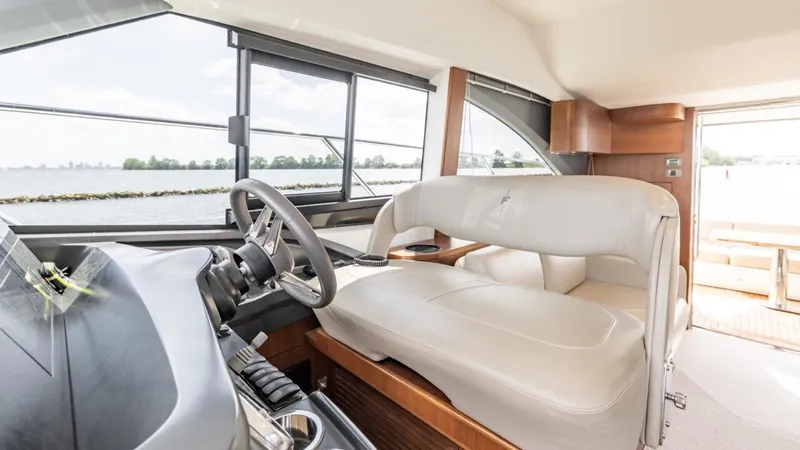  Yacht Photos Pics Interior of 2019 Princess F45 yacht with modern helm and seating, overlooking water.