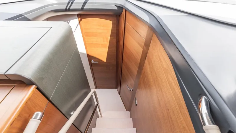  Yacht Photos Pics Staircase inside 2019 Princess F45 yacht with wooden paneling and sleek design.