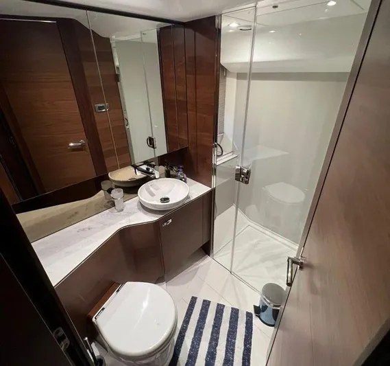  Yacht Photos Pics Luxurious bathroom in 2019 Princess F45 yacht with modern fixtures and glass shower.