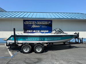 1992 Correct Craft Ski Nautique boat on trailer, parked outside dealership.
