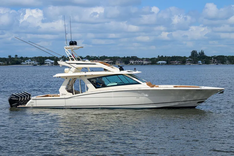 53 Scout Yacht Photos Pics 2021 Scout 530 LXF luxury boat on calm water under a partly cloudy sky.