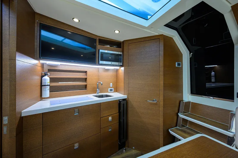53 Scout Yacht Photos Pics Luxurious interior of 2021 Scout 530 LXF yacht with modern kitchenette and seating area.
