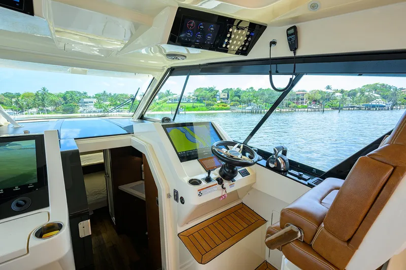 53 Scout Yacht Photos Pics Interior view of 2021 Scout 530 LXF yacht cockpit with modern controls and leather seating.
