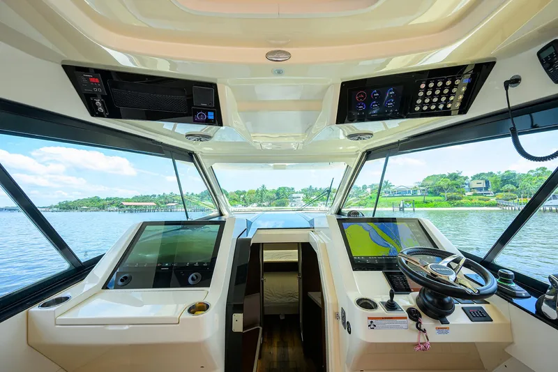 53 Scout Yacht Photos Pics Helm of 2021 Scout 530 LXF boat with advanced navigation systems and scenic water view.